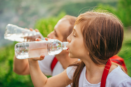 Father and daughter drinking water