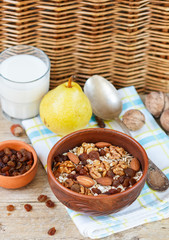Homemade granola with nuts, raisins and seeds in a ceramic bowl for a healthy Breakfast
