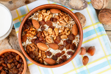 Homemade granola with nuts, raisins and seeds in a ceramic bowl for a healthy Breakfast

