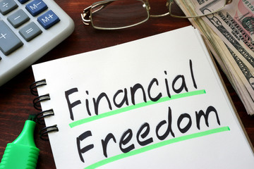 Financial Freedom written on a notepad with marker.