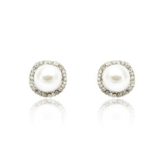 Pair of diamond and natural pearls earrings isolated on white