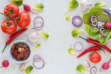 Organic clean vegetables assorted with oil on white wooden backg