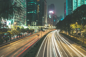 Fototapeta na wymiar Long exposure shot of highway with heavy traffic at night in Hong Kong, China. Speed traffic. Light trails. 