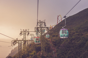 View of a cable car during beautiful sunset  in Hong Kong.  Mountain, sea or ocean landscape. Mountain covered with green forest. 