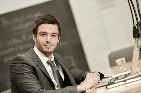 Portrait of smiling Businessman posing  in coworking office