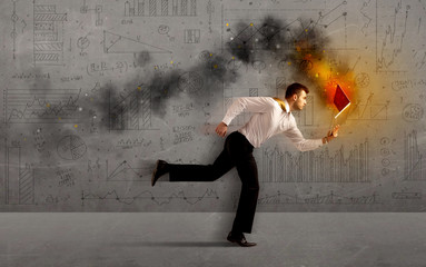 Running business man with fire laptop