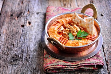 Muhammara dip of sweet peppers with walnuts, cumin, garlic and olive oil.