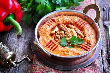 Muhammara dip of sweet peppers with walnuts, cumin, garlic and olive oil.