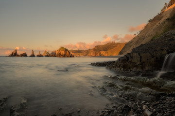 Cliffs and ocean at sunset. Cloudy sky, Cantabria, Spain