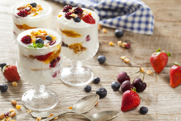 Yogurt with fruits on wooden table