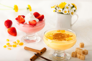 Strawberry pudding with whipping cream and vanilla pudding with cinnamon