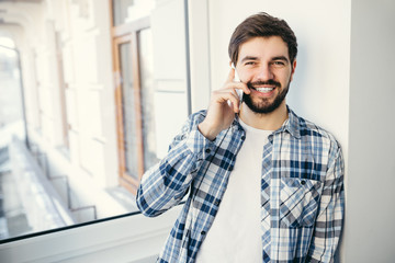 young smiling italian business man talking on cell phone