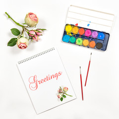 Sketchbook watercolor brushes paper flowers greetings