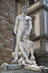 Hercules & Cacus statue on the background of "Palazzo Vecchio" in "Piazza della Signoria" in Florence