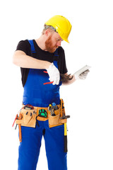 Man builder in the uniform with a tablet