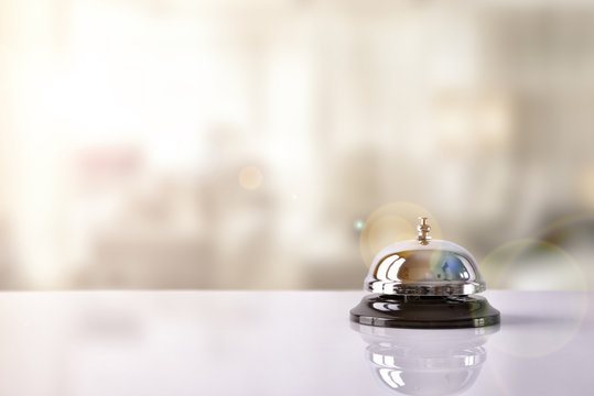 Service bell on hotel reception with Hotel background