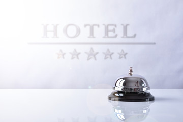 Service bell on hotel reception with Hotel placard background - obrazy, fototapety, plakaty