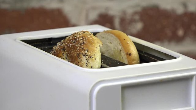 Slow motion of a bagel popping out of the toaster
