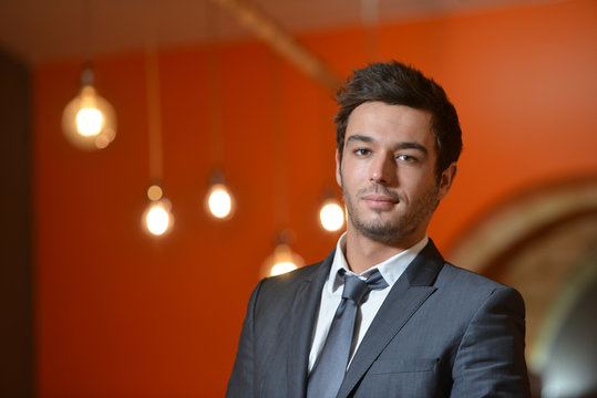 Portrait of smiling Businessman posing  in coworking office