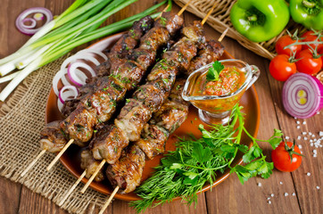 Grilled beef liver kebabs on a dark wooden background