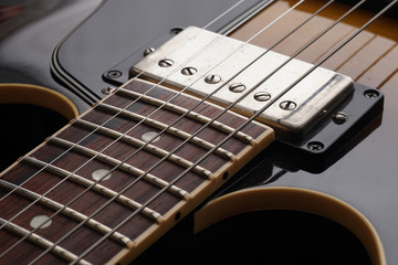 Closeup of old electric guitar. Detail, selective focus.