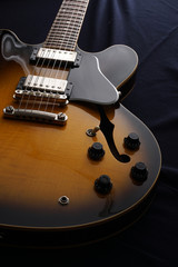 Closeup of old electric guitar. Detail, selective focus.