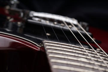 Closeup of old electric guitar. Detail, selective focus.