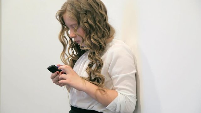 девочка пишет сообщение в телефоне