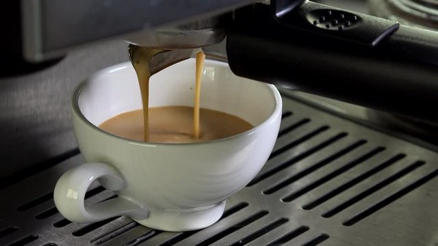 Close-Up Of Coffee Pouring From Espresso Machine