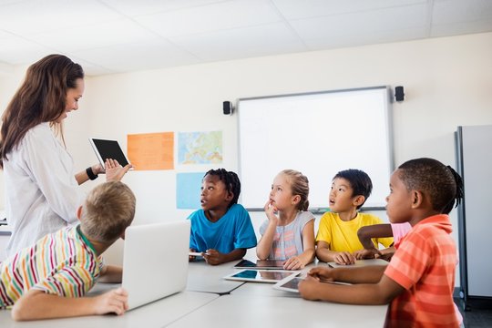 Pupils listening the teacher  - Powered by Adobe