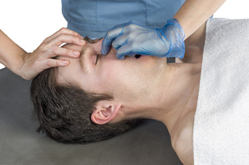 Fototapeta na wymiar Physiotheraphist doing a sinus massage, theraphy.