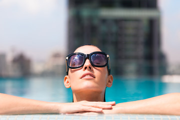 Beautiful woman relaxing in a pool. 