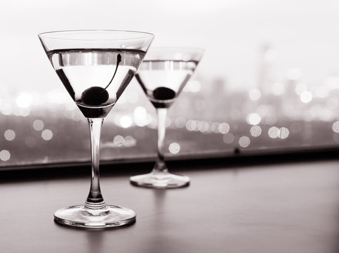 Pair of martini glasses on a bar.