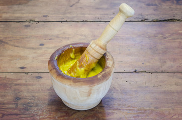 Alioli in a wood mortar on wood.