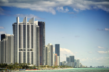 Fototapeta na wymiar Beautiful beach with skyscrapers in Sunny Islands, Miami