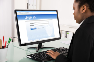 Fototapeta na wymiar Businesswoman Signing Into Website On Computer