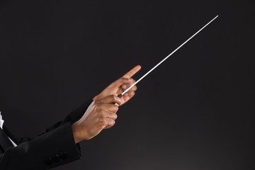 Female Orchestra Conductor Holding Baton