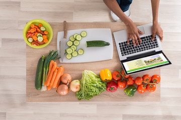 Woman Looking At Recipe On Laptop