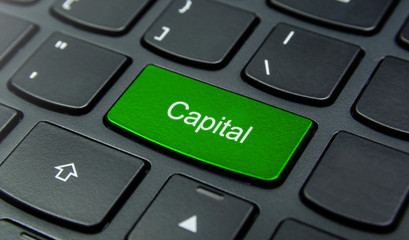 Business Concept: Close-up the Capital button on the keyboard and have Lime, Green color button isolate black keyboard