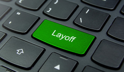 Business Concept: Close-up the Layoff button on the keyboard and have Lime, Green color button isolate black keyboard