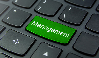 Business Concept: Close-up the Management button on the keyboard and have Lime, Green color button isolate black keyboard