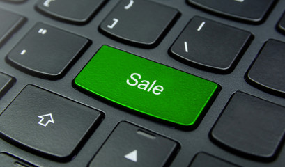 Business Concept: Close-up the Sale button on the keyboard and have Lime, Green color button isolate black keyboard