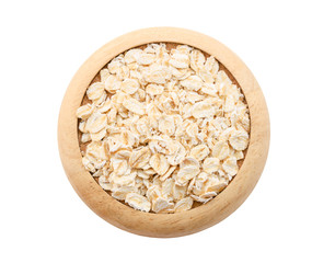 Oat flakes pile in wooden dish.