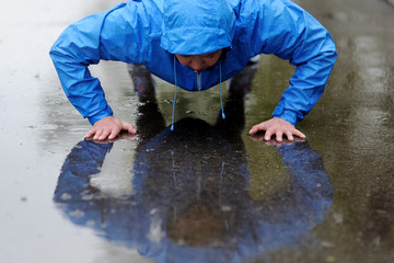 Photo of a young athletic woman exercising in the rain.