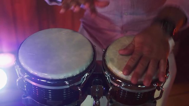 Close-up of man's hands playing congas