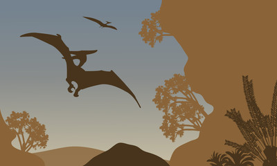 Silhouette of pterodactyl flying in forest © wongsalam77