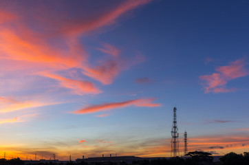 Sky with silhouettes of radio antenna.