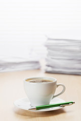 Office workplace with coffee and documents