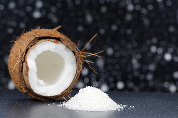 Fresh coconut and coconut desiccated on a stone table