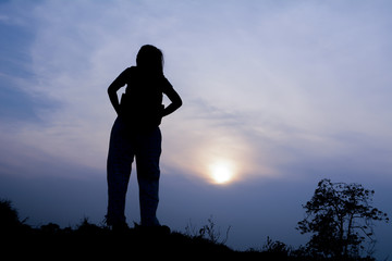 Silhouette women tourists.Background sunset